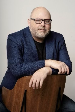 Man in glasses sitting on chair
